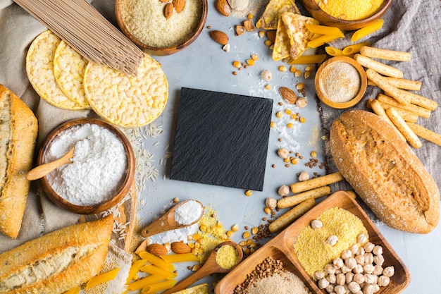 Healthy eating, dieting, balanced food concept. Assortment of gluten free food and flour, almond, corn, rice on a table. Top view flat lay background