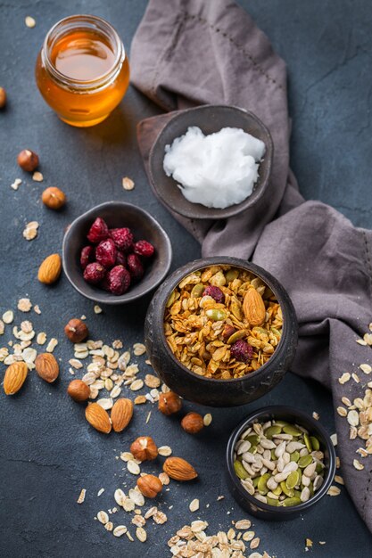 Healthy eating, dieting and nutrition, fitness, balanced food, breakfast concept. Homemade granola muesli with ingredients on a table.