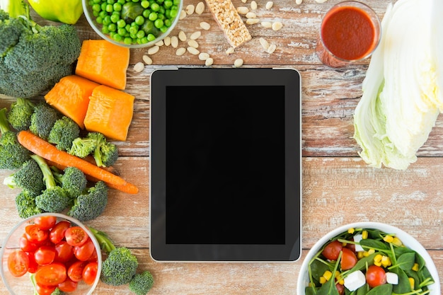 healthy eating, dieting, slimming and weigh loss concept - close up of black blank tablet pc screen and vegetables