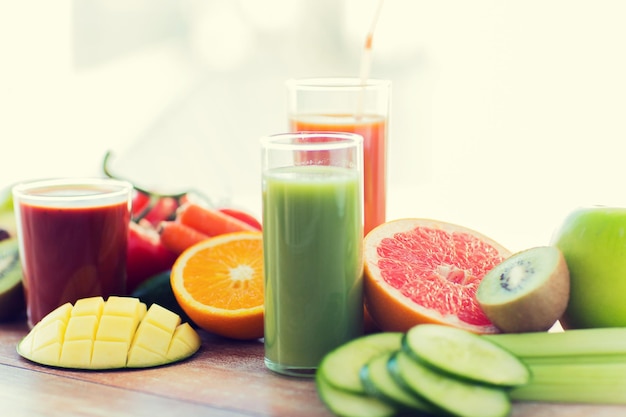 healthy eating, food and diet concept- close up of fresh juice glass and fruits on table