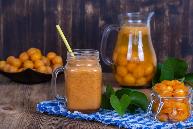 Healthy eating food diet and vegetarian concept smoothie from apricot and peach in mug closeup Fresh apricot and juice on wooden background