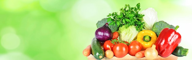 Healthy eating and green grocery shopping banner group of selected fresh vegetables on abstract nature background copy space