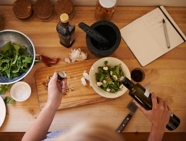 Healthy eating High angle shot of a woman preparing a salad in a kitchen