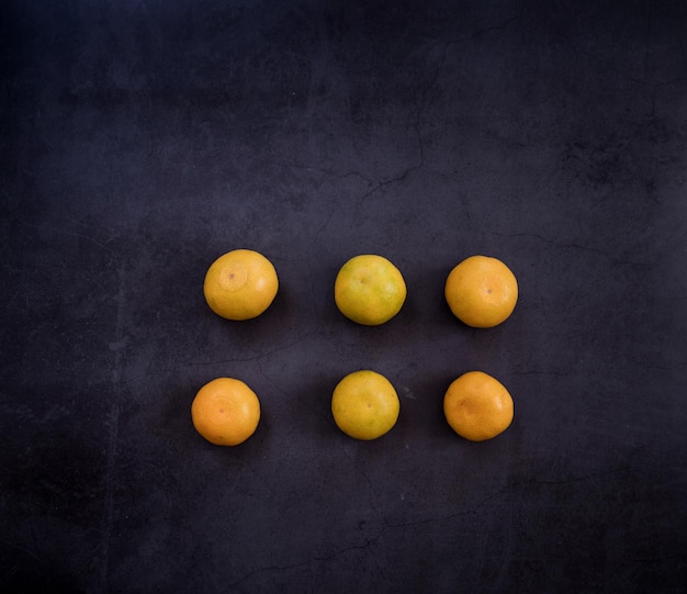 Healthy eating ripe yellow tangerines on a dark background place for text christmas mood