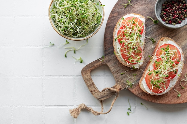 Healthy Eating Sandwiches with tomatoes avocado and fresh microgreens