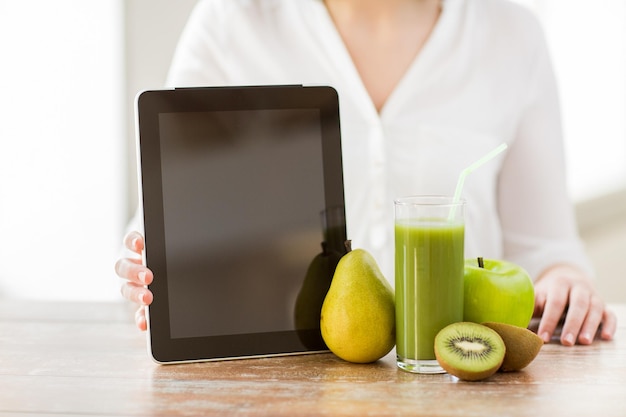 写真 健康的な食事、テクノロジー、ダイエット、人のコンセプト – タブレットpc、果物、新鮮なジュースをテーブルに置いた女性の手の接写