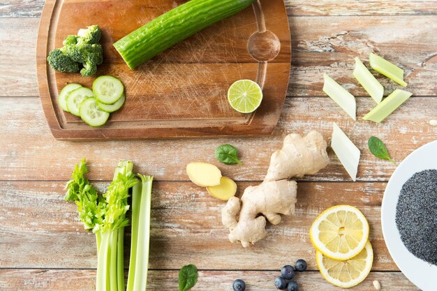 healthy eating, vegetarian food, culinary and diet concept - close up of superfood ingredients on wooden table