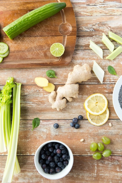 healthy eating, vegetarian food, culinary and diet concept - close up of superfood ingredients on wooden table