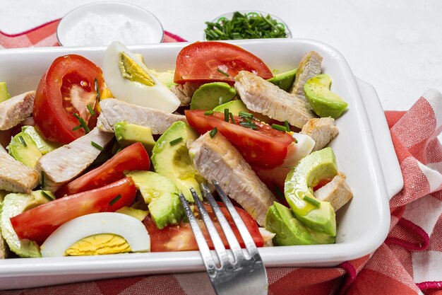 Healthy Egg, chicken, avocado and tomato salad with olive oil