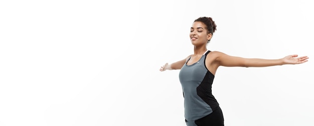 Healthy and Fitness concept Portrait of young beautiful African American with her hands outstretched and closing eyes feeling relax Isolated on white studio background