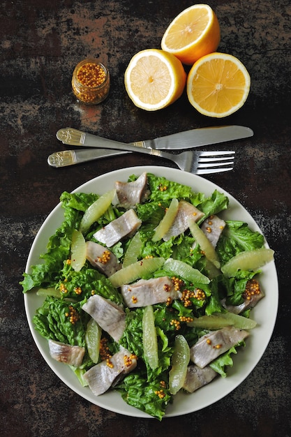 Healthy fitness salad with lemon and fish.