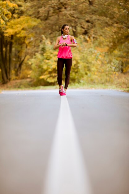 Healthy fitness woman training for marathon outdoors in alleyway