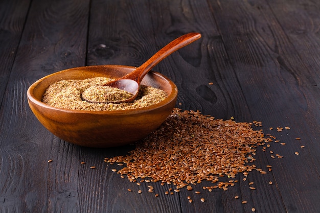 Healthy flax seeds in a wood spoon.