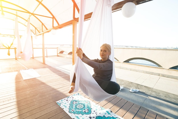 Healthy and fly Yoga Concept. happy smiling girl in a fly yoga class