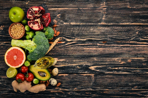 Healthy food background Concept of Healthy Food Fresh Vegetables Nuts and Fruits On a wooden background Top view Copy space