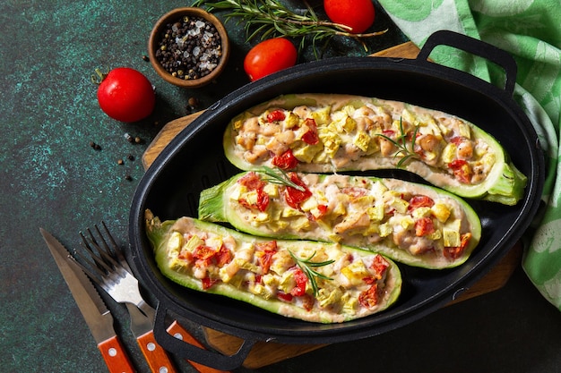 Healthy food Baked zucchini stuffed with meat and tomatoes Top view Copy space