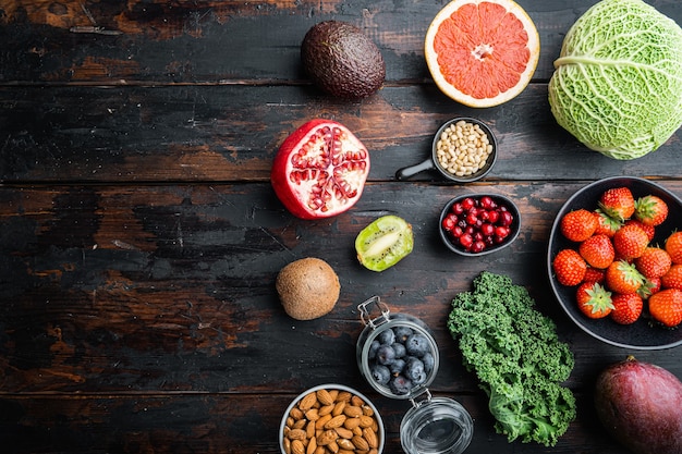 Healthy food and clean eating selection, top view on dark wooden table, with copy space.