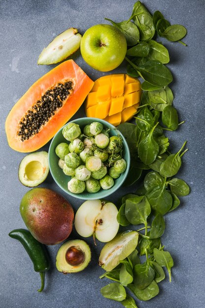 Healthy food clean food selection fruits vegetables superfoods leaf vegetable on a gray concrete background