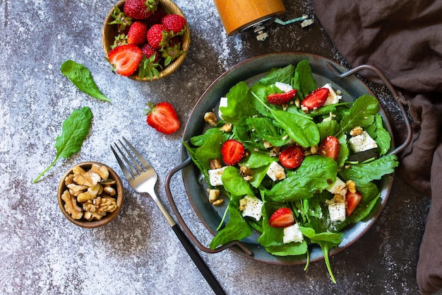 Healthy food concept Diet salad plate Summer salad with strawberries fetacheese and walnut