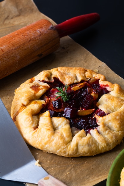 Healthy food concept preparation for Homemade rustic organic roasted beets and onion caramel galette pie