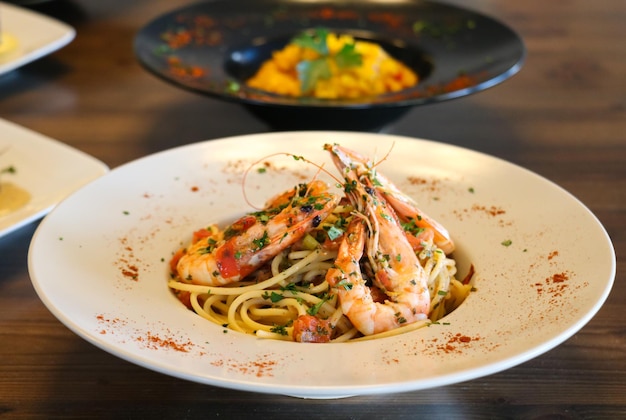 Healthy food concept Spaghetti with shrimps prawns Blur plates with foods background