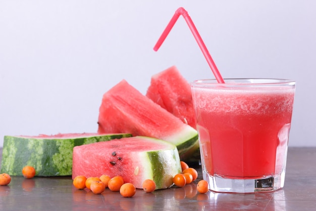 Healthy food concept sweet summer dessert Freshly squeezed watermelon juice smoothie with watermelon slices on dark background