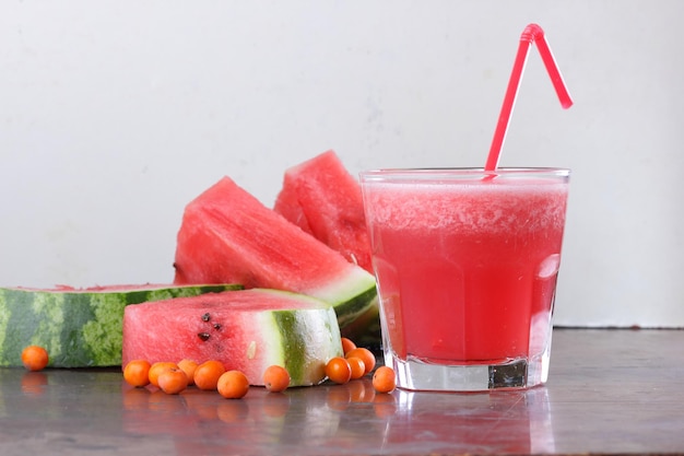 Healthy food concept sweet summer dessert Freshly squeezed watermelon juice smoothie with watermelon slices on dark background