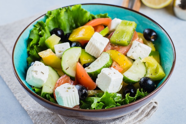 Healthy Food Concept.Traditional Greek salad with fresh vegetables, feta cheese and black olives