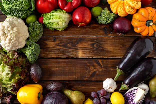 Healthy food concept. Vegetables and fruits on wooden background