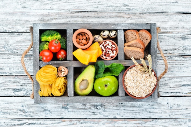 Healthy food containing carbohydrates bread pasta avocados flour pumpkin broccoli beans spinach On a white background Top view Free copy space