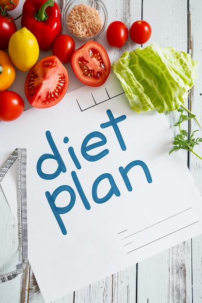 Photo healthy food and diet planning weight loss concept notebook with phrase diet plan