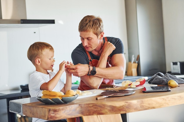 Healthy food Father and son is indoors at home together