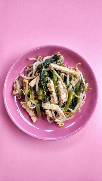 Healthy food from a mixture of kale, bean sprouts and tempeh. Cooked using onions, garlic and chilie