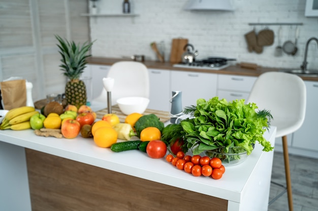 Healthy food, fruit, vegetable, berries , leaf vegetable on a table in a kitchen background