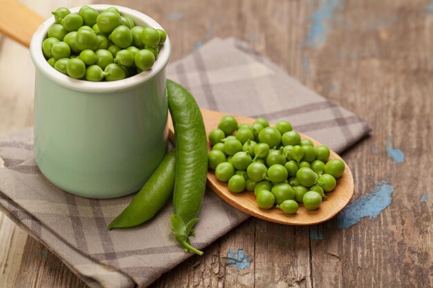 Healthy food Green peas on wooden table
