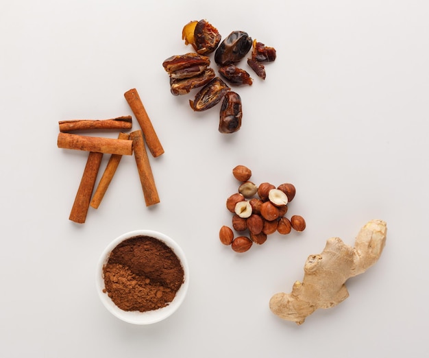 Healthy food. ingredients for detox smoothie, cinnamon, ginger, nuts, on white background, top view, copy space.