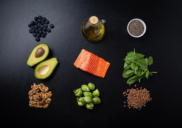 Photo healthy food ingredients rich in omega3 fatty acids on black background