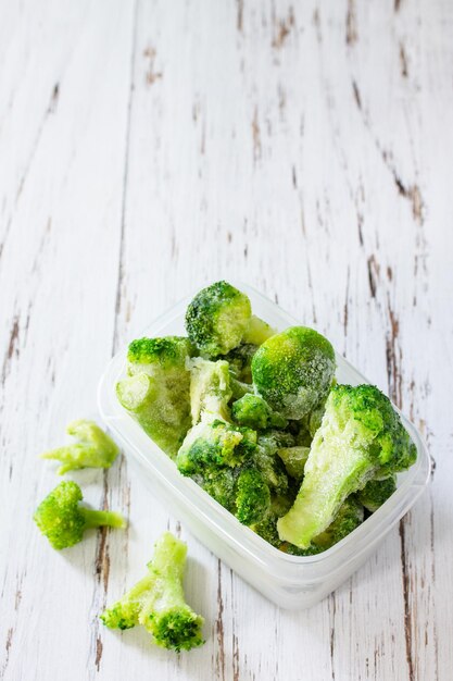 Healthy food is frozen Containers with frozen broccoli Copy space