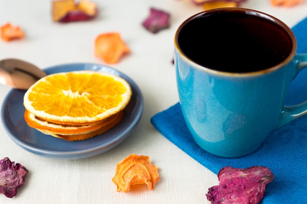 Healthy food organic nutrition. Sliced and dried apple, orange, carrot and beetroot and cup of tea 