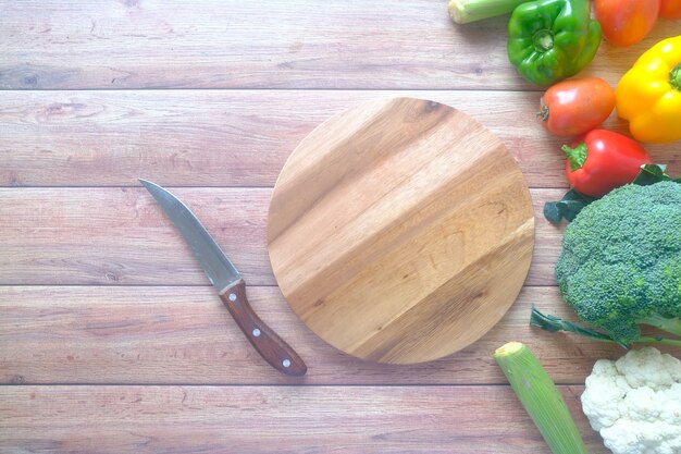 Healthy food selection with fresh vegetables on chopping board on table