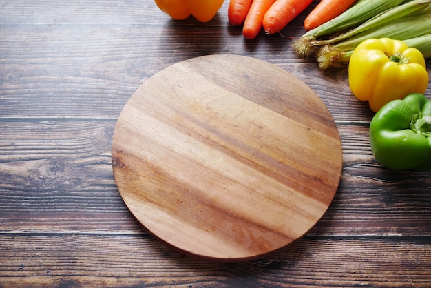 Healthy food selection with fresh vegetables on chopping board on table