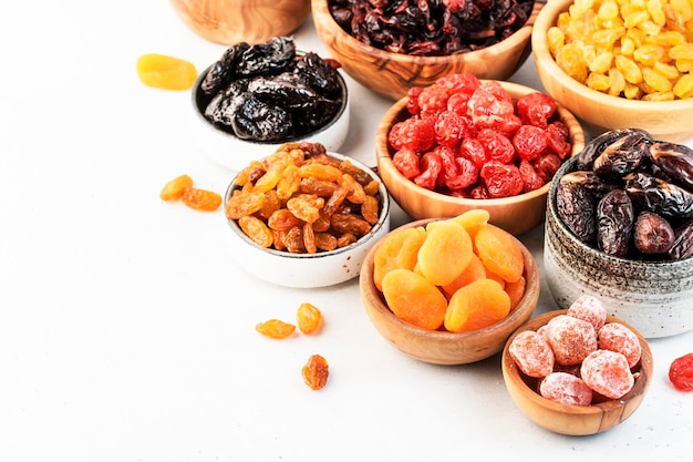 Healthy food snacks natural dried fruits mix in bowls on white background