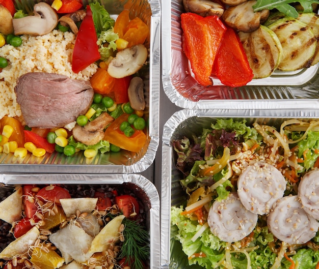 Healthy food take away in boxes top view on wooden table