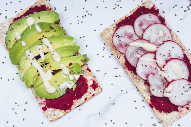 Cibo sano con pane crudo, avocado, ravanello e patate