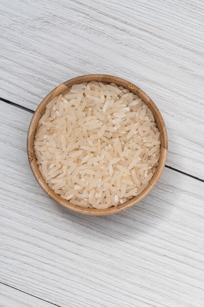 Healthy food. Wooden bowl with parboiled rice. Rice close-up