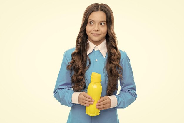 Healthy food for your delight happy child hold yellow bottle isolated on white liquid food