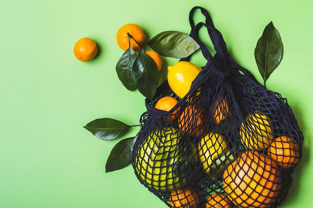 Healthy food and zero waste concept set of citrus in mesh textile bag