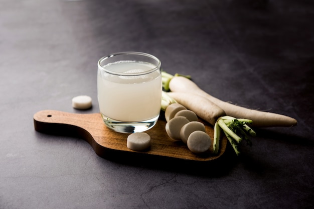 Healthy Fresh daikon juice or Mooli extract drink in a glass with raw mule