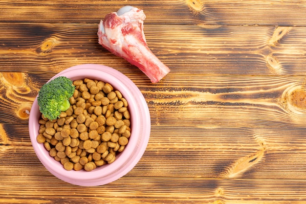 Healthy fresh pet food ingredients on dark surface