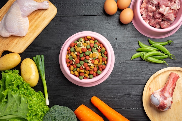 Healthy fresh pet food ingredients on dark surface